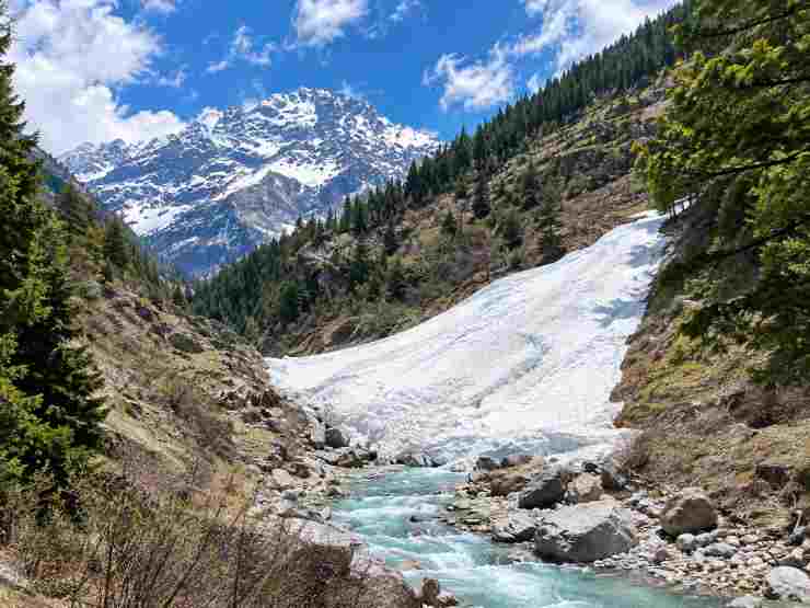 Glacier Point mountain trail with snow and flowing stream near Tosh, Himachal Pradesh